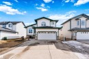 Attached two-car garage with overhead door and transom window accents - 2915 151A Avenue Nw, Edmonton, AB 
