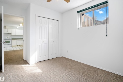Neutral carpet flooring, white walls, and a ceiling fan - 2915 151A Avenue Nw, Edmonton, AB 