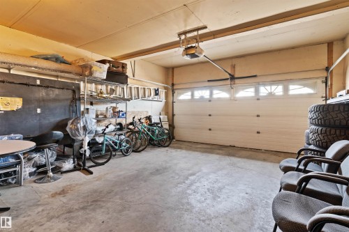 Concrete flooring and an automatic garage door with upper window inserts - 2915 151A Avenue Nw, Edmonton, AB 
