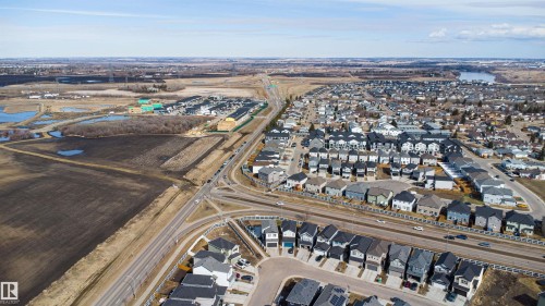 Aerial perspective of a developed residential neighborhood with a distant body of water - 2915 151A Avenue Nw, Edmonton, AB 