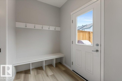 Mudroom with built-in bench seating and wall-mounted hooks - 7113 177A Avenue Nw, Edmonton, AB - Indoor Photo Showing Other Room