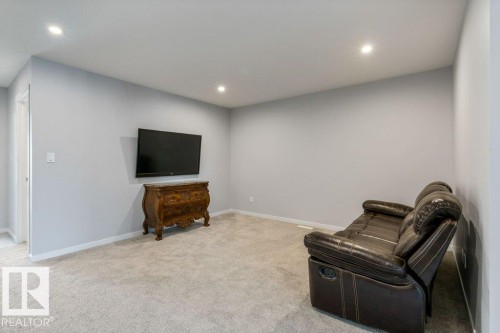 Spacious room featuring light grey wall paint and recessed ceiling lighting - 7113 177A Avenue Nw, Edmonton, AB - Indoor