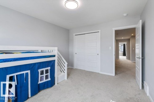 Carpeted room with a flush-mount ceiling light - 7113 177A Avenue Nw, Edmonton, AB - Indoor Photo Showing Bedroom