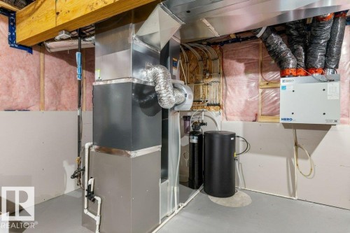 HVAC system with associated ductwork, water filtration system, and exposed wood beams - 7113 177A Avenue Nw, Edmonton, AB - Indoor Photo Showing Basement