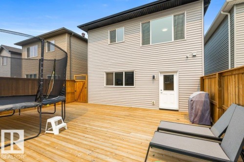 Expansive wood deck with a privacy fence and direct access to the interior via a white door - 7113 177A Avenue Nw, Edmonton, AB - Outdoor With Deck Patio Veranda With Exterior