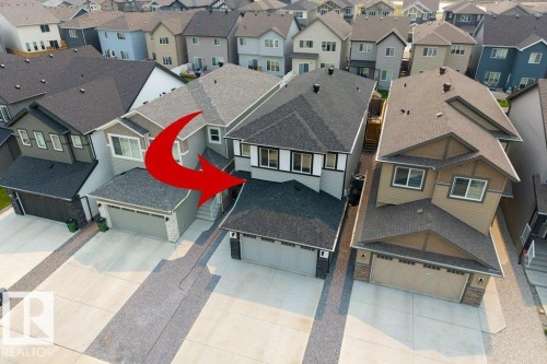 Two-story residence featuring a gray exterior with dark trim accents and multiple windows - 7113 177A Avenue Nw, Edmonton, AB - Outdoor