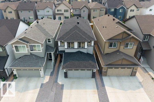 Modern residential property featuring a two-car garage, light gray siding, and an asphalt shingle roof - 7113 177A Avenue Nw, Edmonton, AB - Outdoor With Facade