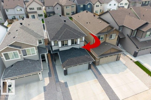 Contemporary two-story residence featuring a dark shingle roof and light gray siding - 7113 177A Avenue Nw, Edmonton, AB - Outdoor