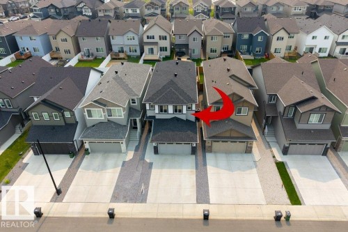 Modern two-story residence featuring a dark gray roofline, a light gray facade, and a single-car garage - 7113 177A Avenue Nw, Edmonton, AB - Outdoor With Facade