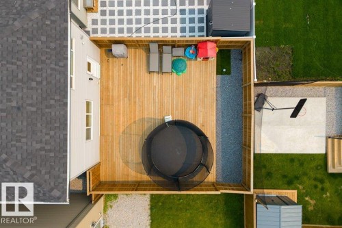Rear exterior with a large wood deck featuring a light wood finish - 7113 177A Avenue Nw, Edmonton, AB -  With Exterior