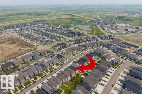 Aerial overview of a residential neighborhood featuring detached homes with varied architectural styles and dark-toned roofs - 7113 177A Avenue Nw, Edmonton, AB -  With View