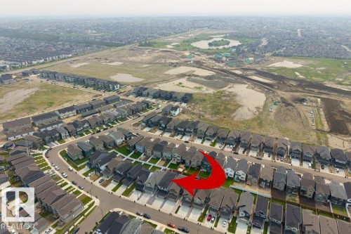 Aerial perspective showcasing a residential neighborhood with numerous single-family homes, paved streets, and green spaces - 7113 177A Avenue Nw, Edmonton, AB - Outdoor With View