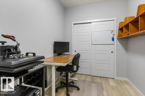 Light gray walls with wood-finish flooring - 7113 177A Avenue Nw, Edmonton, AB - Indoor Photo Showing Office