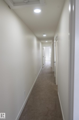 Recessed ceiling lighting, light-toned walls, and neutral carpeting - #64 2710 66 St Sw Sw, Edmonton, AB 