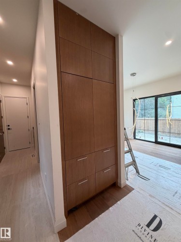 Integrated wood-finish cabinetry with silver-tone hardware, recessed ceiling lighting, and wood-finish flooring - 10223 130 Street Nw, Edmonton, AB 