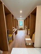 Custom built-in storage, wood-finish flooring, recessed lighting, and a window - 