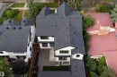 Multi-level exterior with dark shingle roofing, white siding, and black trim - 10223 130 Street Nw, Edmonton, AB 