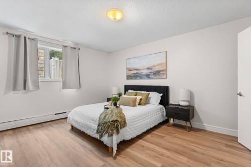 Wood-finish flooring, white walls, and a window with a white frame - #106 10735 81 Av Nw, Edmonton, AB 