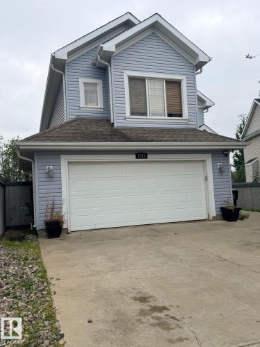 Two-story residence featuring light blue siding and white trim - 8715 11 Avenue Sw, Edmonton, AB 