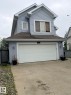 Two-story residence featuring light blue siding and white trim - 8715 11 Avenue Sw, Edmonton, AB 