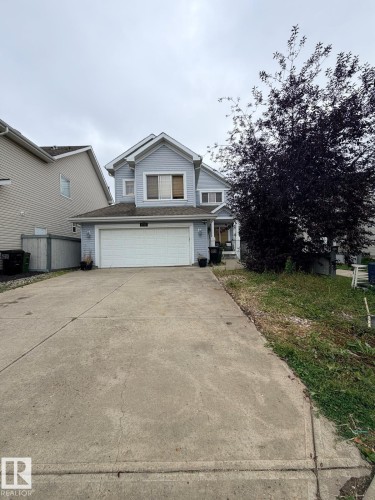 Two-story residence with light blue siding - 8715 11 Avenue Sw, Edmonton, AB 