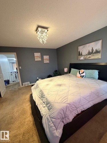 Recessed lighting, ceiling-mounted crystal chandelier, textured ceiling, carpet flooring, neutral wall color - 8715 11 Avenue Sw, Edmonton, AB 