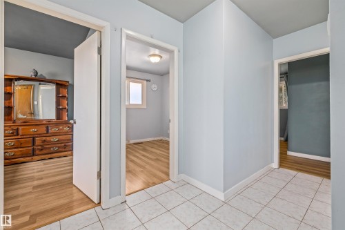 White square tile flooring in the hallway - 13320 123 Street Nw, Edmonton, AB - Indoor Photo Showing Other Room
