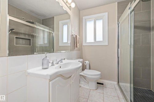 Bathroom featuring a white vanity with integrated sink, chrome faucet, and overhead vanity lighting - 13320 123 Street Nw, Edmonton, AB - Indoor Photo Showing Bathroom