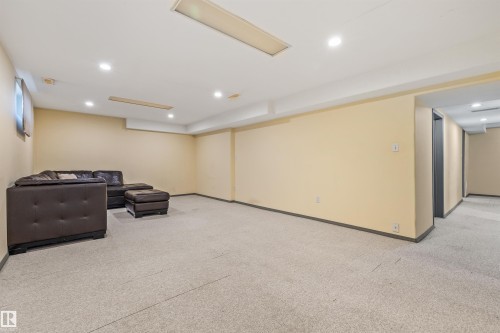 Spacious finished lower level featuring recessed lighting, a dropped ceiling, and light-toned carpeting - 13320 123 Street Nw, Edmonton, AB - Indoor Photo Showing Basement