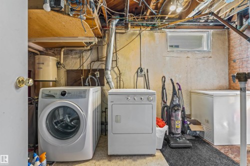 Basement laundry area featuring a front-loading washing machine and a top-loading dryer - 13320 123 Street Nw, Edmonton, AB - Indoor Photo Showing Laundry Room