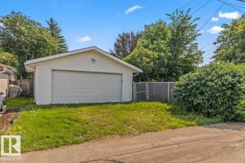Detached two-car garage with white siding, gable roof, and concrete apron - 13320 123 Street Nw, Edmonton, AB - Outdoor