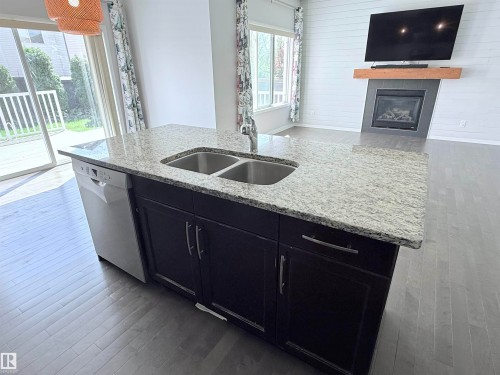 7819 173 Avenue Nw, Edmonton, AB - Indoor Photo Showing Kitchen With Fireplace With Double Sink