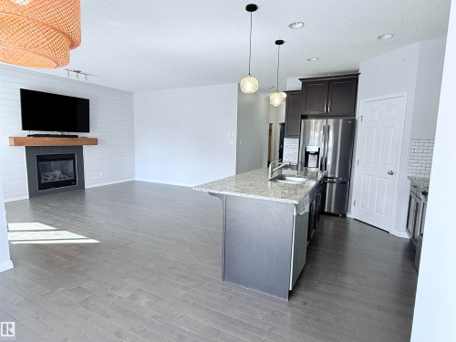 7819 173 Avenue Nw, Edmonton, AB - Indoor Photo Showing Kitchen With Fireplace With Upgraded Kitchen