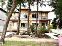 New construction duplex featuring multiple windows, covered entryways, and concrete pathways - 12909 69 Street Nw, Edmonton, AB 