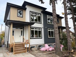 Modern exterior with multi-toned siding, black-framed windows, and a covered front entry - 