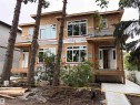 Two-story structure with multiple large windows, wood frame construction, and a covered entry porch - 12909 69 Street Nw, Edmonton, AB 