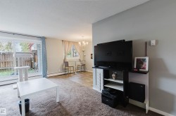 Sliding glass door leading to an outdoor area, gray wall paint, and overhead lighting - 