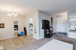 Recessed lighting, chandelier, neutral wall paint, tile flooring, and carpeted area - 