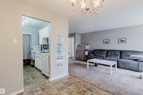 Kitchen area with white cabinetry and a built-in dishwasher - #126 5125 Riverbend Rd Nw, Edmonton, AB 
