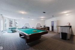 Recreational space featuring a pool table, built-in bar, extensive window line, and recessed lighting - 
