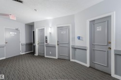 Patterned carpet flooring with gray wall paneling - 