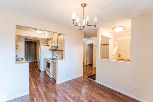 Wood-finish flooring throughout the main living areas - #4 3221 119 St Nw, Edmonton, AB 