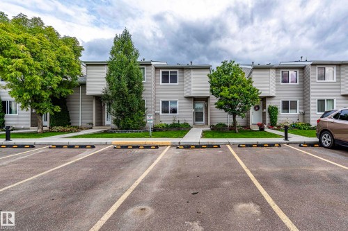 Light gray siding exterior with white window frames - #4 3221 119 St Nw, Edmonton, AB 