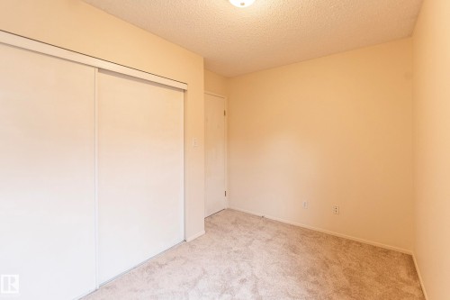 Wall-to-wall carpeting with neutral wall tones - #4 3221 119 St Nw, Edmonton, AB 
