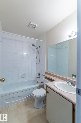 White tiled shower and tub combination - #4 3221 119 St Nw, Edmonton, AB 