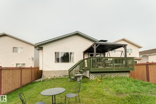 Private wooden deck featuring a gazebo, green painted railings, and lattice skirting - 3519 22 Street Nw, Edmonton, AB 