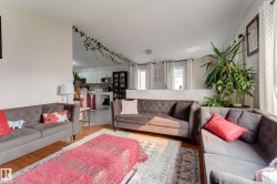 Wood-finish flooring throughout, with a partial wall separating living area from kitchen - 