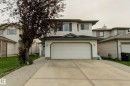 Two-story structure with light-colored siding, an attached two-car garage, and a concrete driveway - 3519 22 Street Nw, Edmonton, AB 