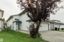 White siding exterior with a covered entry, attached garage, and a concrete driveway - 3519 22 Street Nw, Edmonton, AB 
