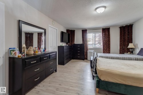 Light wood-finish flooring, white walls, and a multi-pane window - 3519 22 Street Nw, Edmonton, AB 